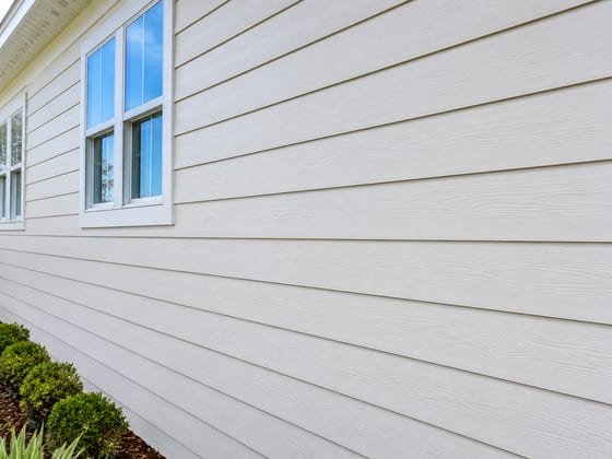 After: the same siding soft-washed clean and bright